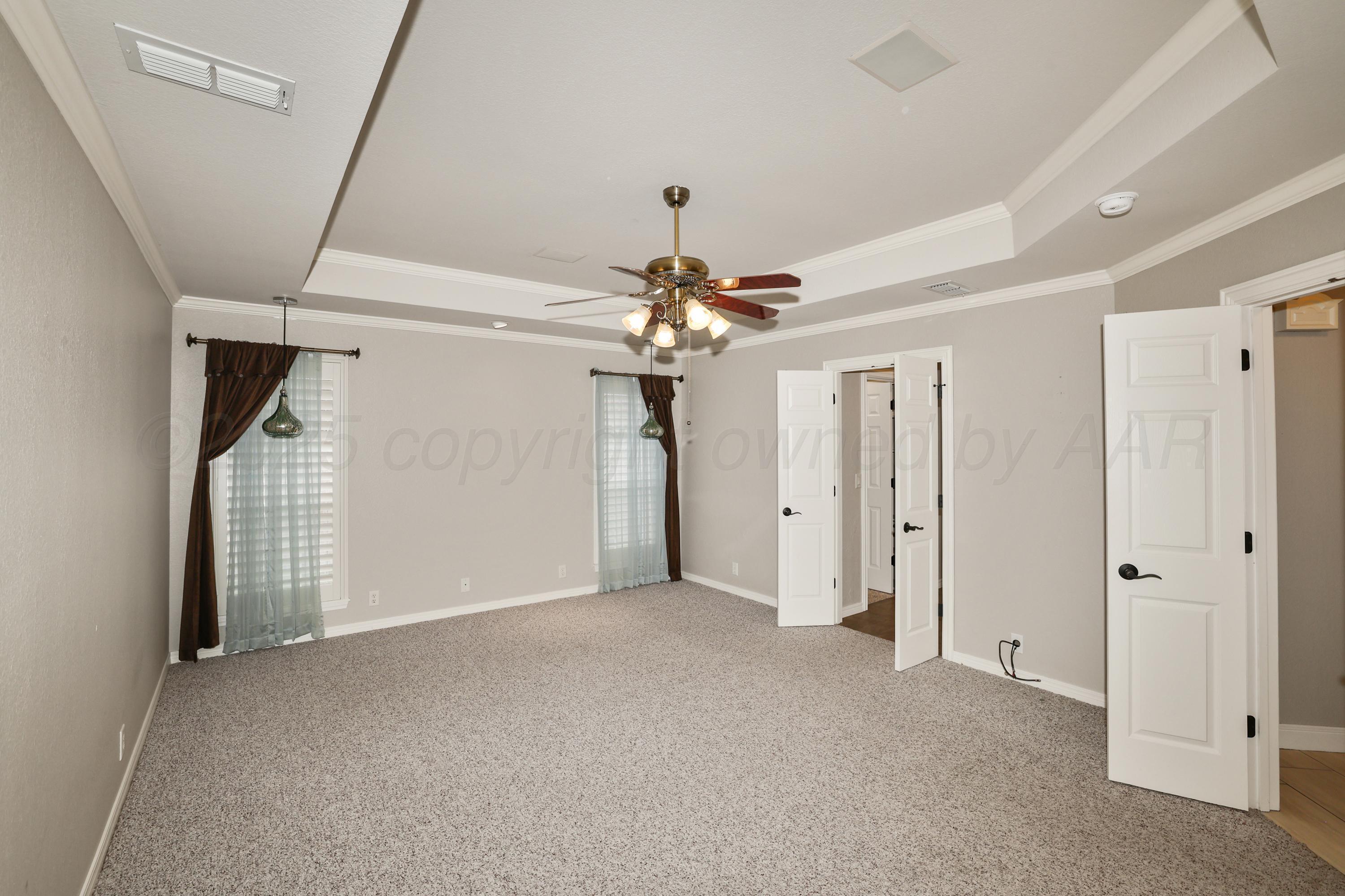 6506 Bayberry Lane Amarillo, TX 79124 - Photo 15 of 32 a view of a livingroom with a ceiling fan window and entryway