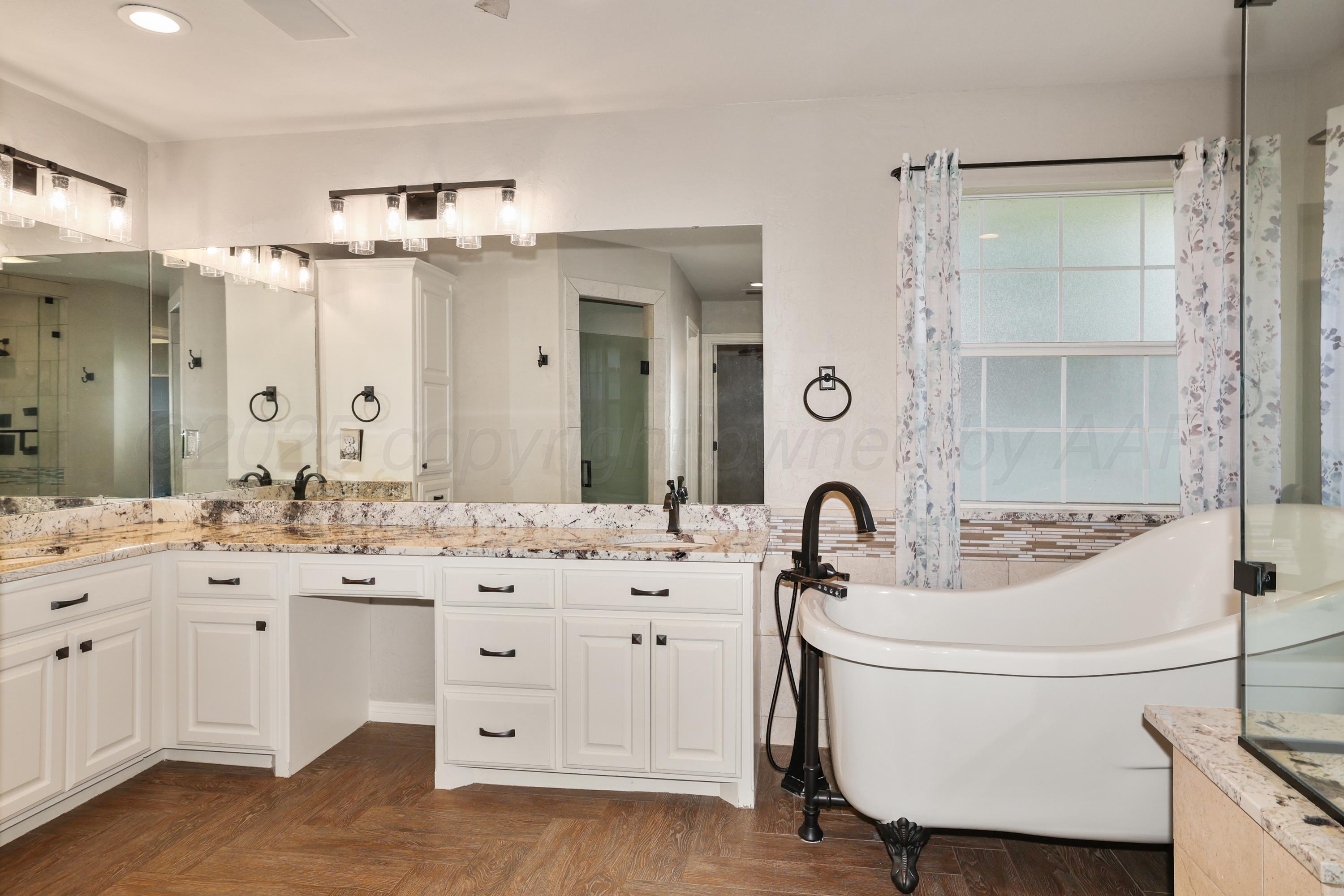 6506 Bayberry Lane Amarillo, TX 79124 - Photo 17 of 32 a bathroom with a double vanity sink mirror and bathtub