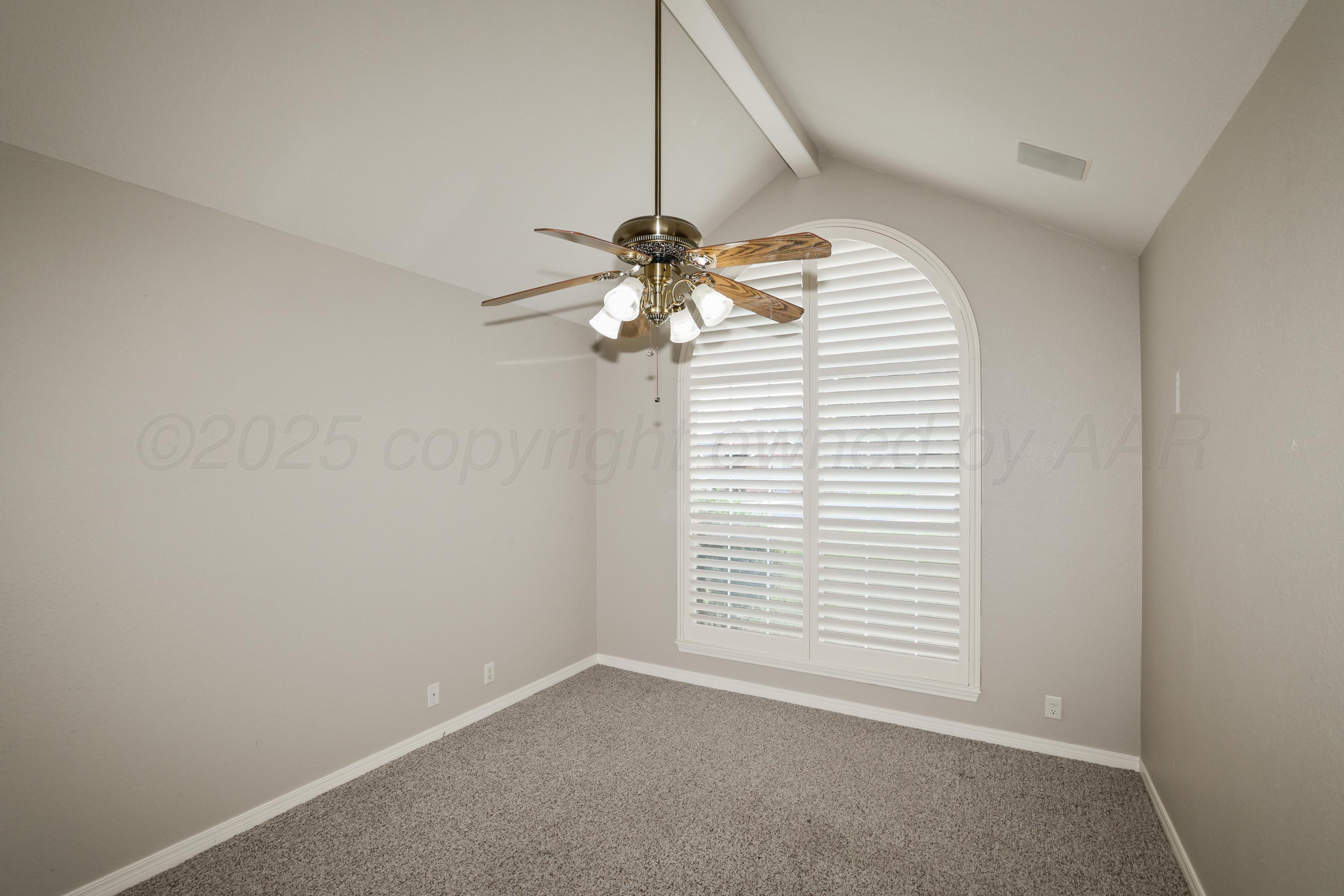 6506 Bayberry Lane Amarillo, TX 79124 - Photo 22 of 32 an empty room with windows and fan