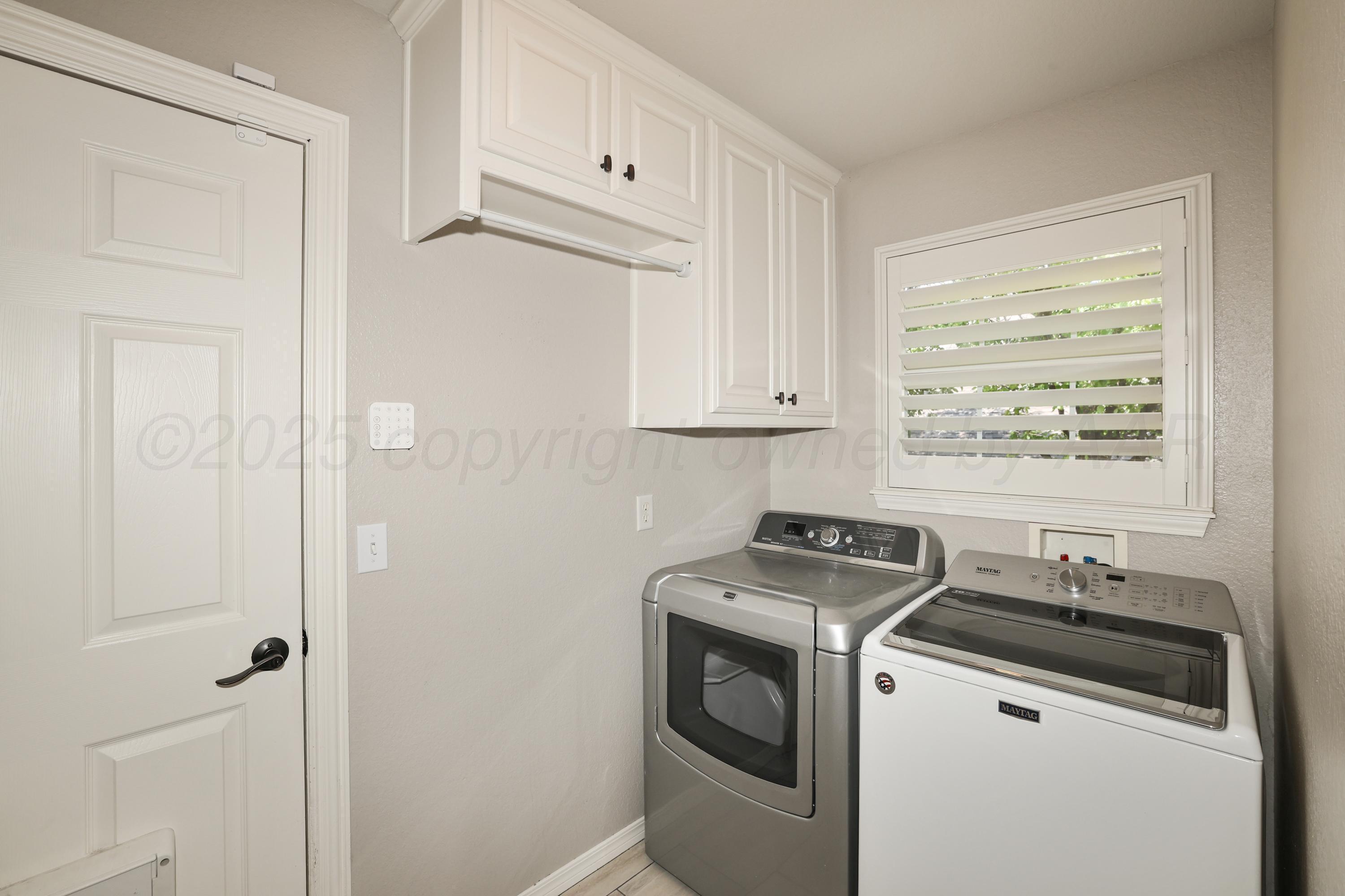 6506 Bayberry Lane Amarillo, TX 79124 - Photo 27 of 32 a view of a storage and utility room with washer and dryer