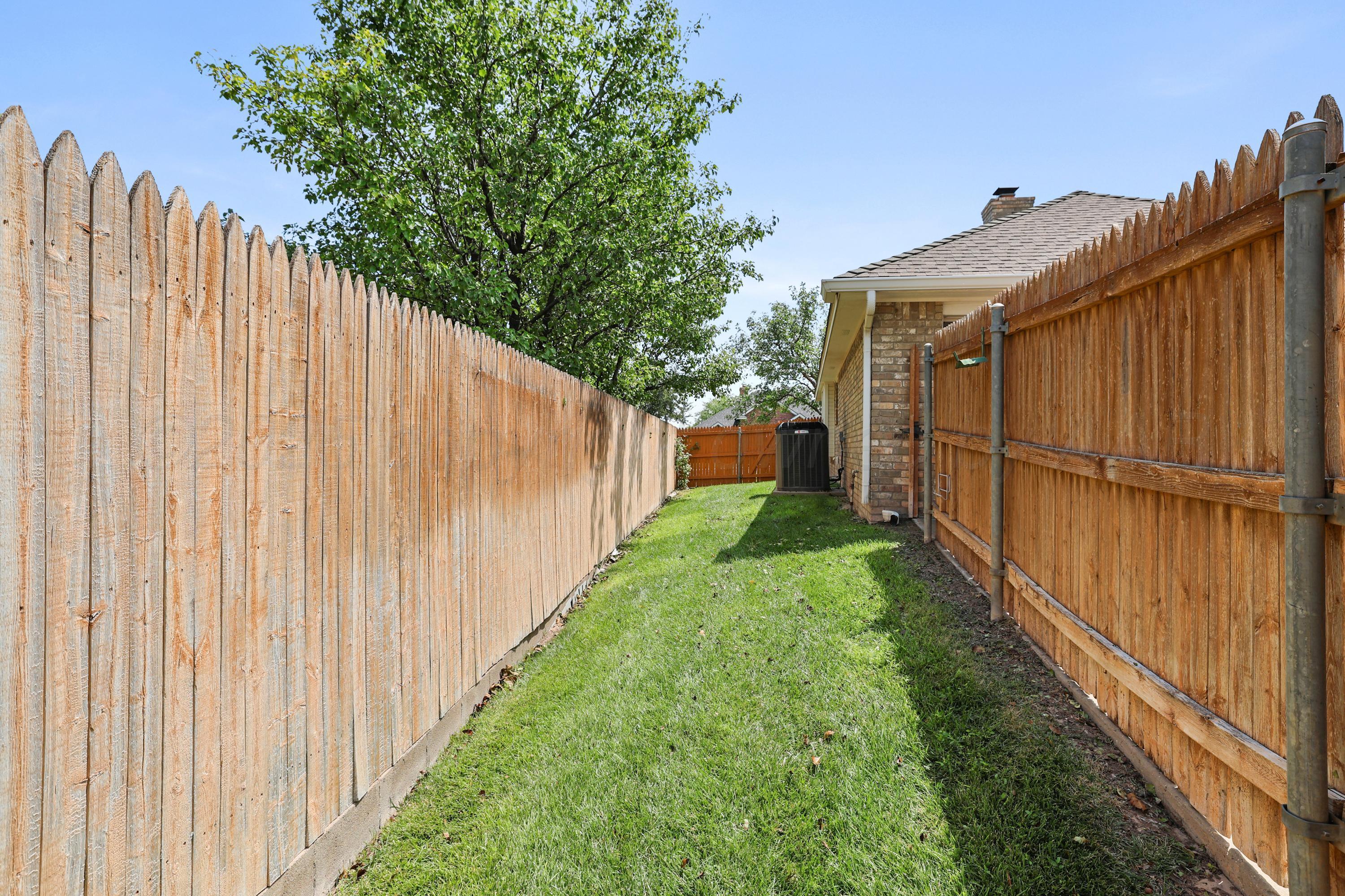 6506 Bayberry Lane Amarillo, TX 79124 - Photo 32 of 32 a view of a backyard with wooden fence