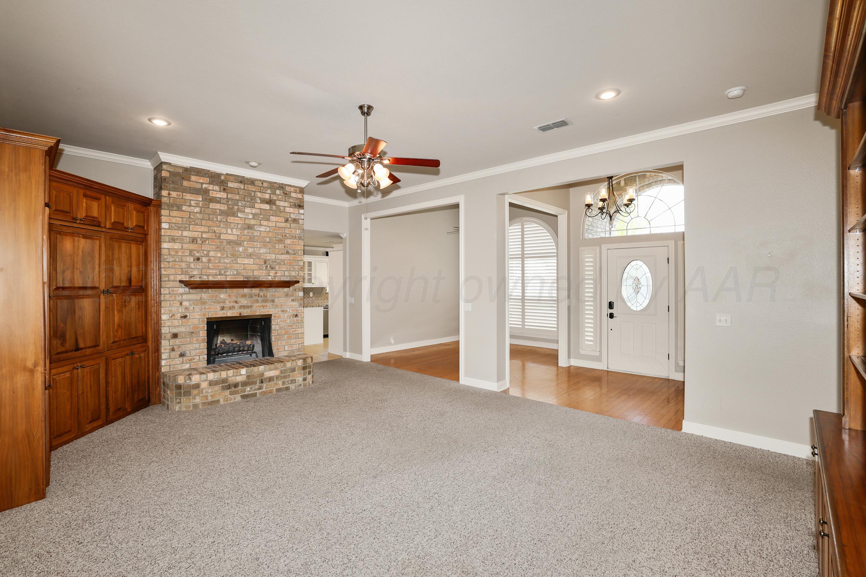 6506 Bayberry Lane Amarillo, TX 79124 - Photo 5 of 32 a view of a livingroom with a fireplace and window