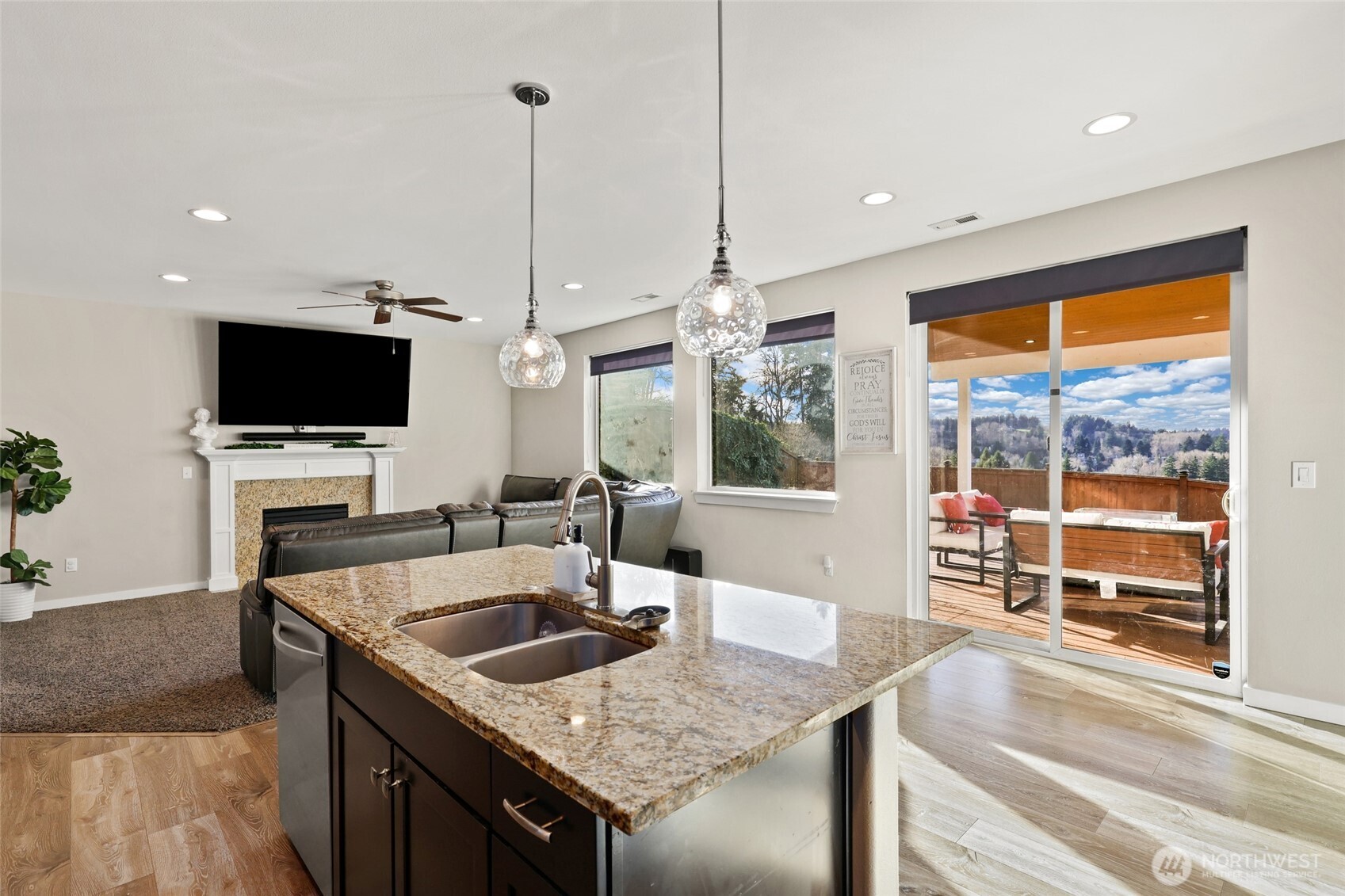 1320 34th Street Southeast Puyallup, WA 98372 - Photo 13 of 40 a kitchen with a stove a sink a counter top space and living room view