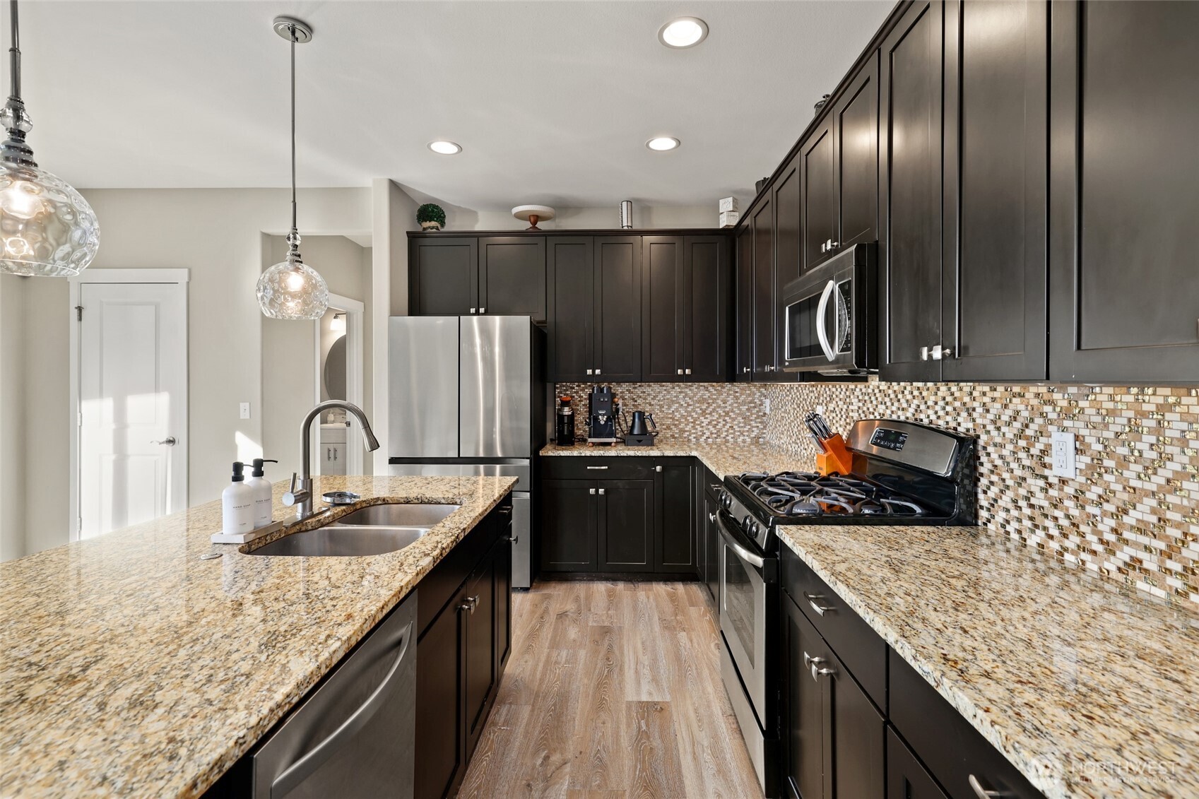 1320 34th Street Southeast Puyallup, WA 98372 - Photo 15 of 40 a kitchen with granite countertop stainless steel appliances a sink a counter top space a stove and cabinets
