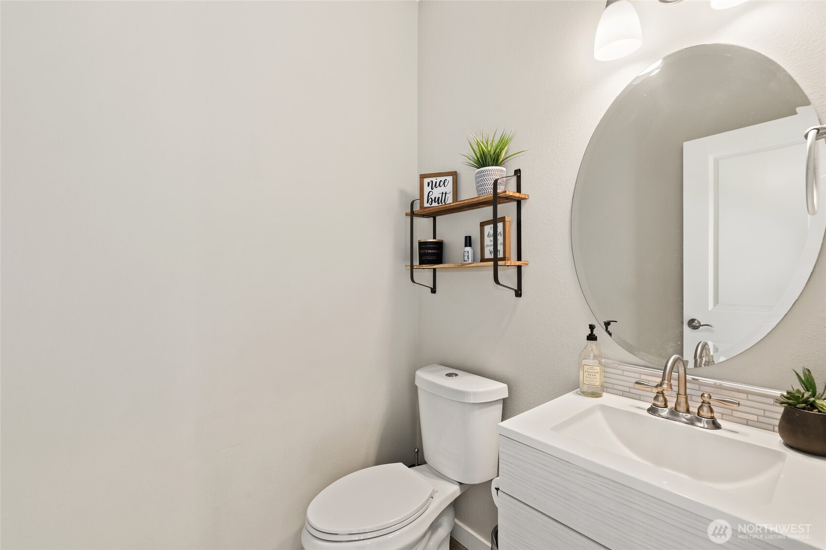 1320 34th Street Southeast Puyallup, WA 98372 - Photo 16 of 40 a white toilet sitting next to a bathroom sink