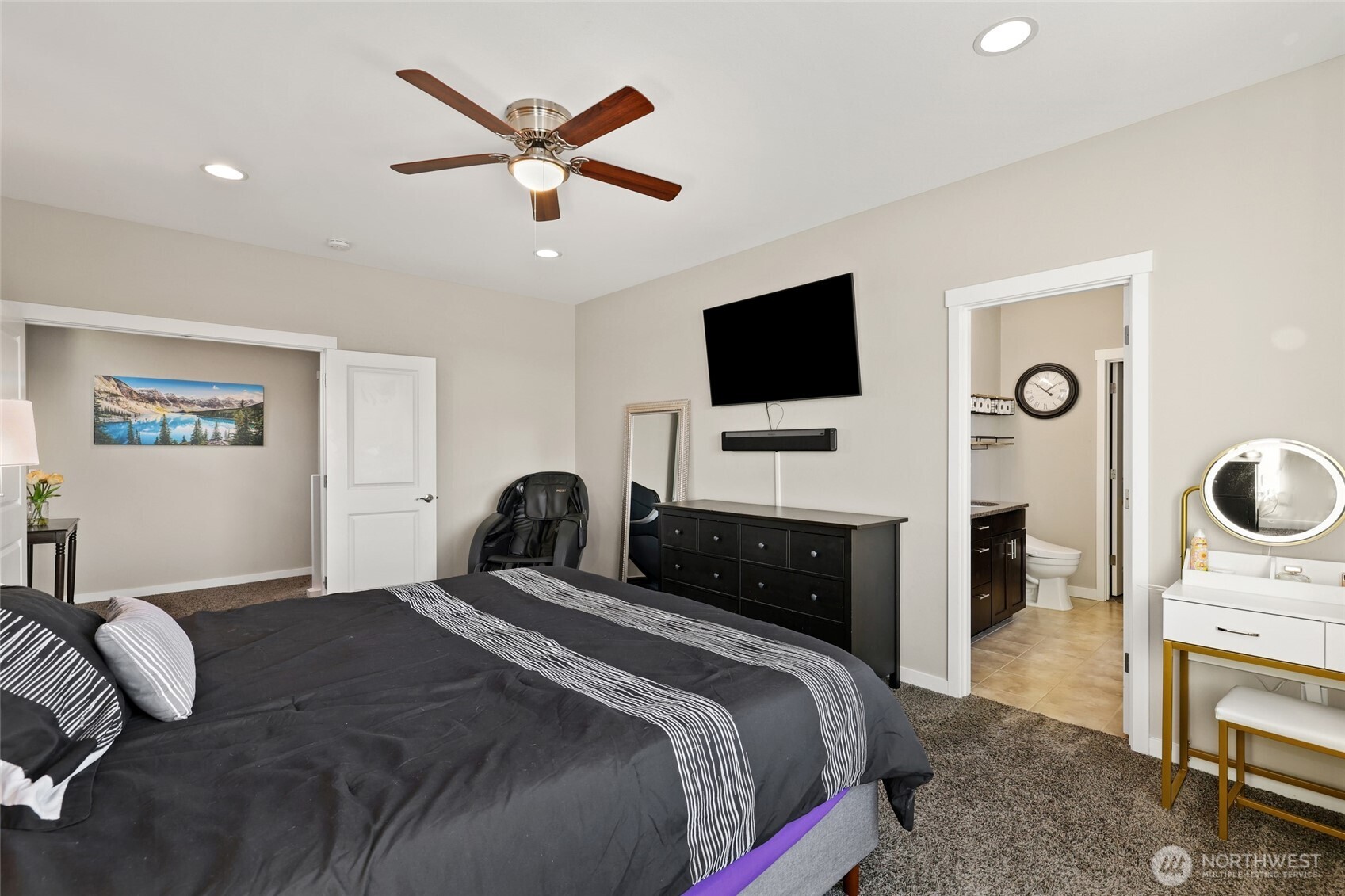 1320 34th Street Southeast Puyallup, WA 98372 - Photo 19 of 40 a bedroom with a bed and a flat screen tv