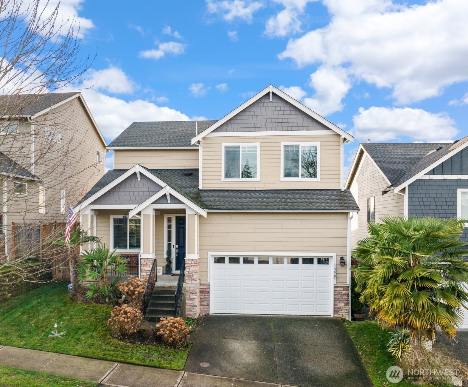 1320 34th Street Southeast Puyallup, WA 98372 - Photo 2 of 40 a front view of a house with a yard and garage