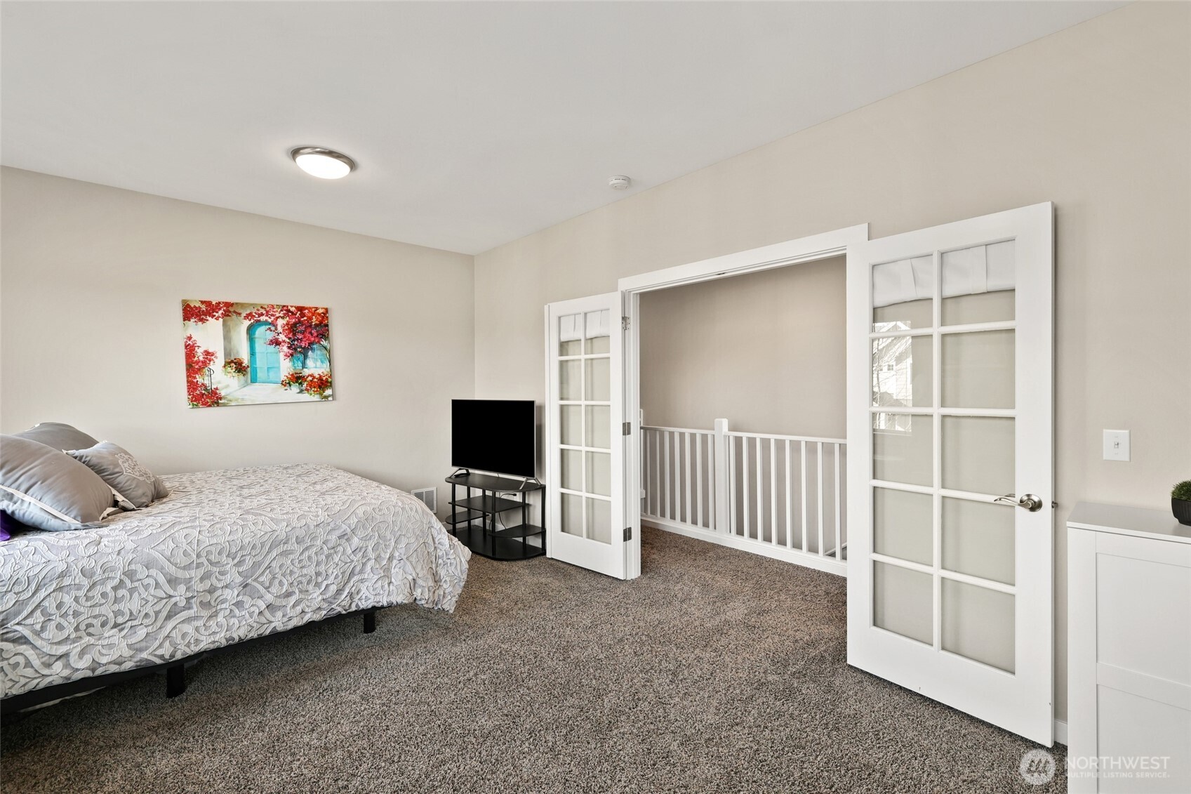 1320 34th Street Southeast Puyallup, WA 98372 - Photo 24 of 40 a bedroom with a bed and a flat screen tv