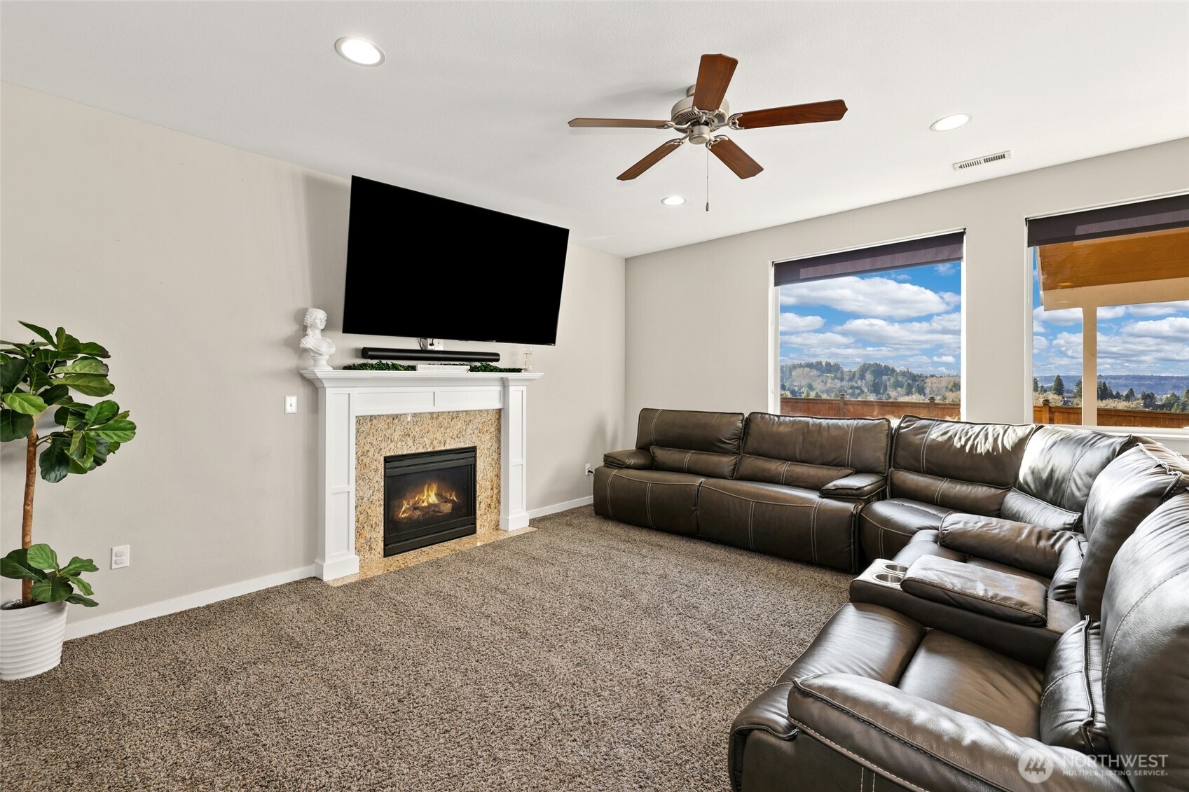 1320 34th Street Southeast Puyallup, WA 98372 - Photo 10 of 40 a living room with furniture a flat screen tv and a fireplace