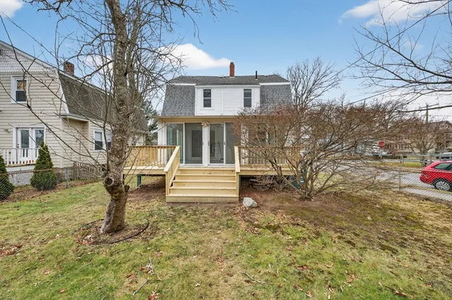 a front view of a house with a yard table and chairs