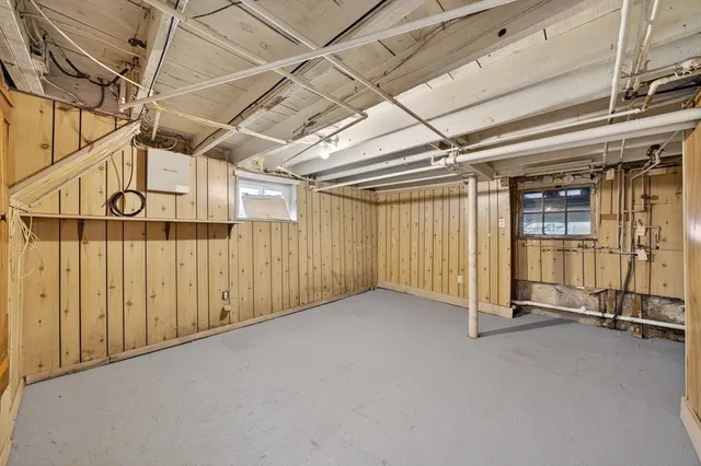 a view of a house with a yard and large tree