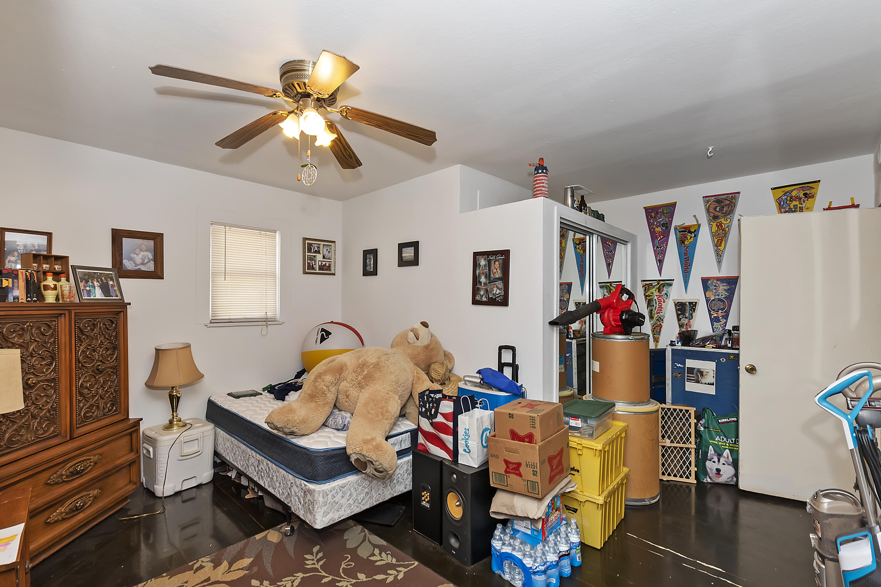 2691 Mulberry Street Riverside, CA 92501 - Photo 9 of 14 a bedroom with furniture and a chandelier