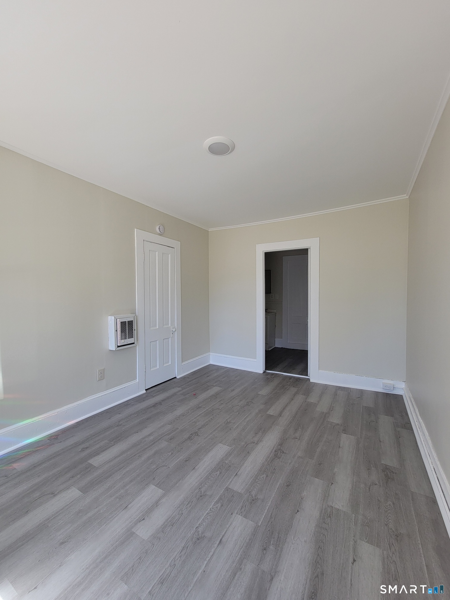 120 North Street, Unit 1L Windham, CT 06226 - Photo 1 of 1 a view of an empty room with wooden floor and closet