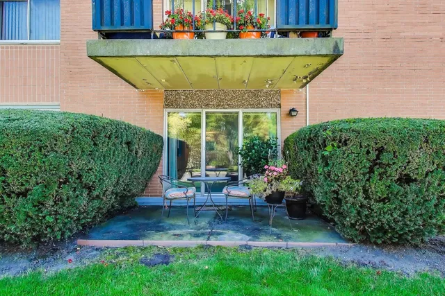 a view of a house with sitting area and garden