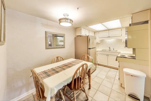 a kitchen with stainless steel appliances kitchen island granite countertop a refrigerator and a stove top oven