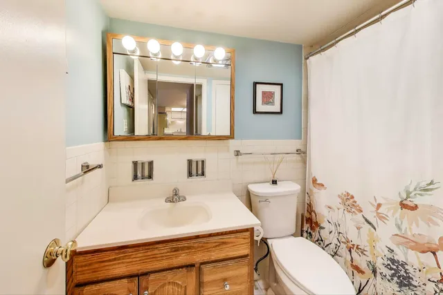 a bathroom with a sink a toilet and mirror