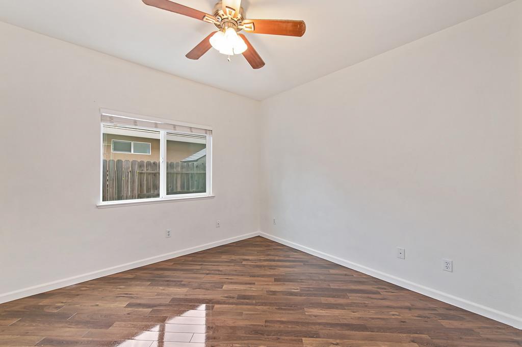 3524 Riojo Way Rancho Cordova, CA 95670 - Photo 20 of 47 an empty room with wooden floor fan and windows