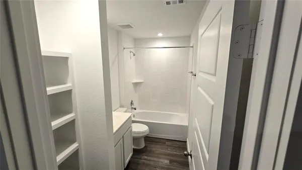 a bathroom with a granite countertop shower toilet and a sink