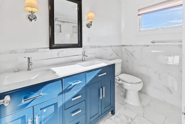a view of a room with wooden floor and white walls