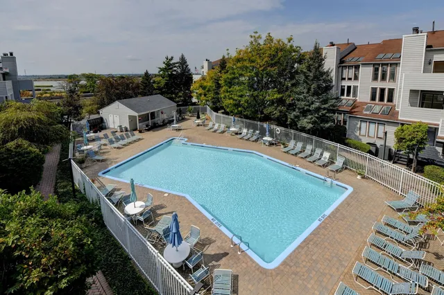 a view of a house with swimming pool and sitting area