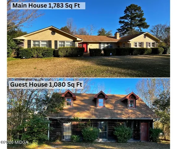 a view of a house with a yard and sitting area