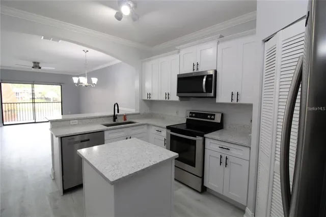 a kitchen with a sink stove and microwave