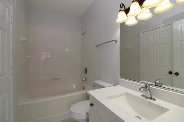 a bathroom with a sink a toilet and bathtub