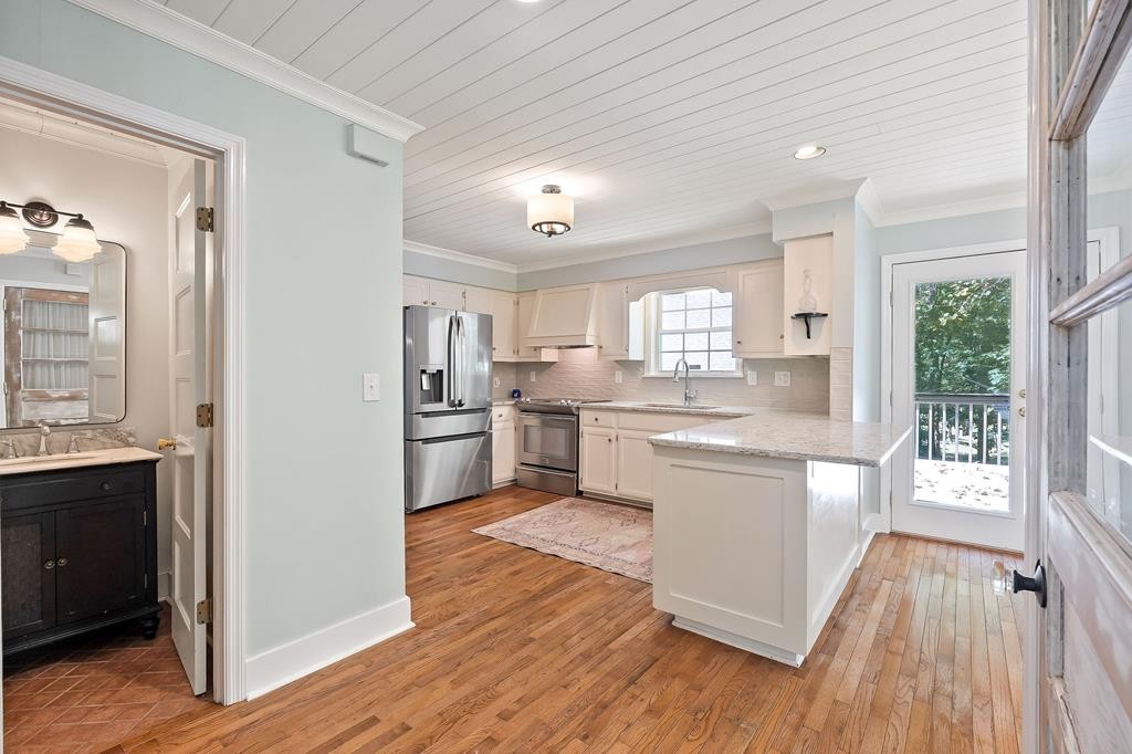 480 Jamestown Road Cookeville, TN 38501 - Photo 12 of 46 a kitchen with white cabinets and wooden floor