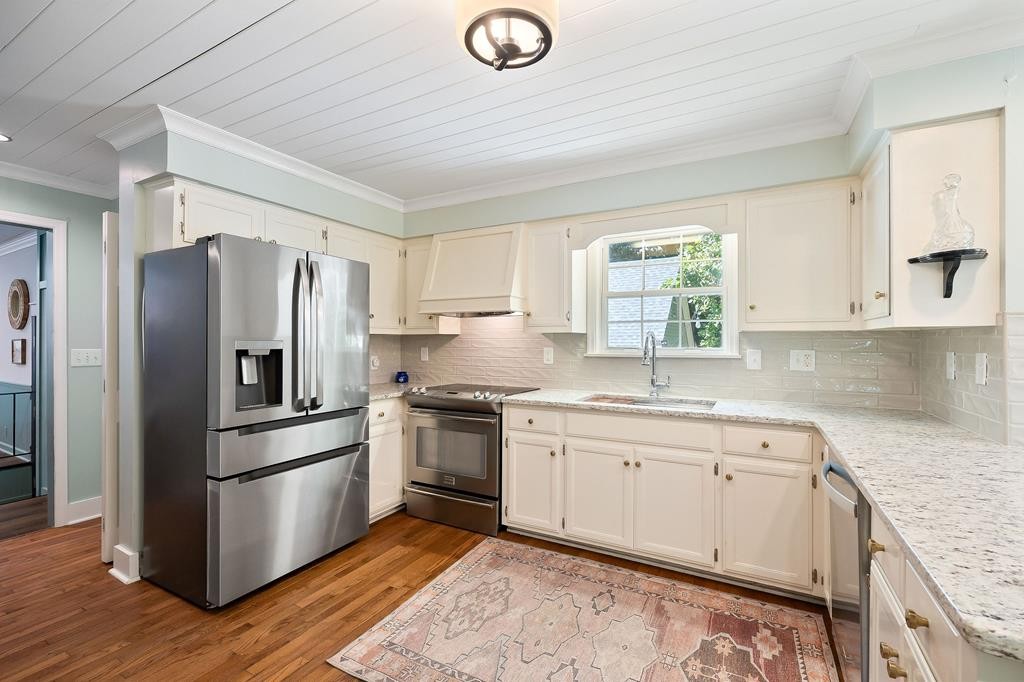 480 Jamestown Road Cookeville, TN 38501 - Photo 7 of 46 a kitchen with granite countertop stainless steel appliances a sink cabinets and a window