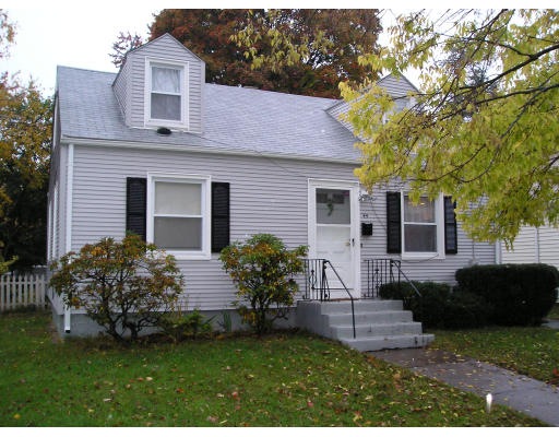 44 Eloise Street Springfield, MA 01118 - Photo 2 of 5 a front view of a house with a garden and plants