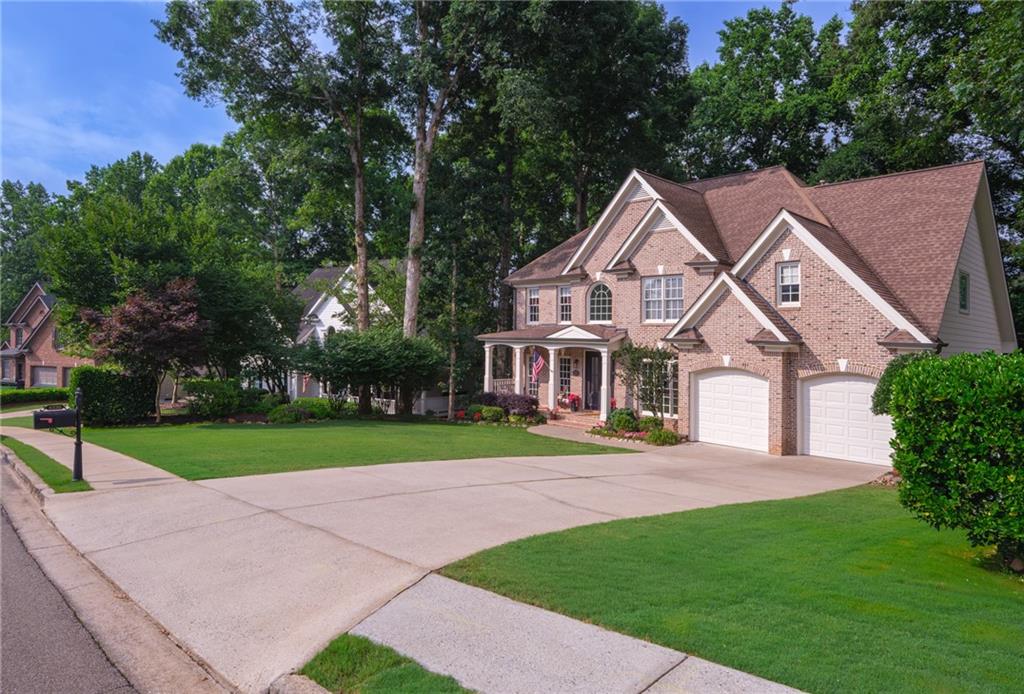 4330 Farmbrook Lane Cumming, GA 30041 - Photo 43 of 46 a front view of a house with a yard and trees