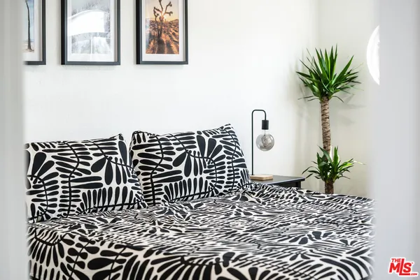 a bed sitting in a bedroom and a table