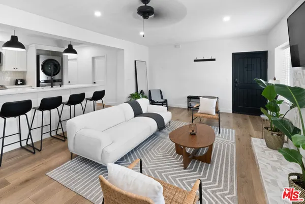 a kitchen with stainless steel appliances kitchen island a stove a sink and a refrigerator