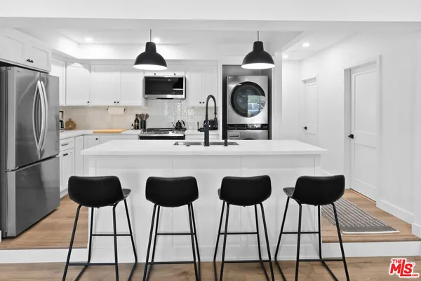 a kitchen with a sink a stove and a refrigerator