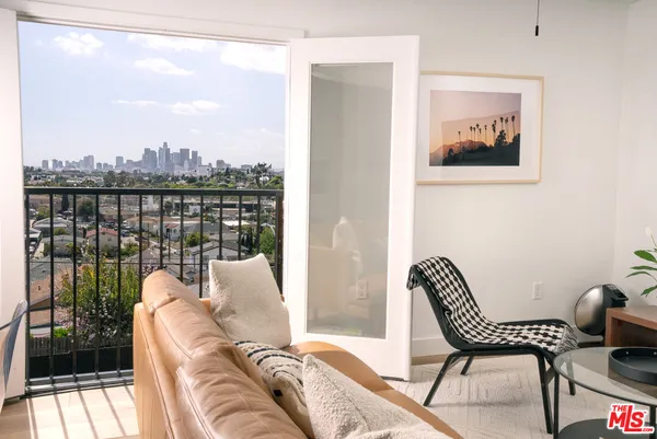 a balcony view with a couch and wooden floor