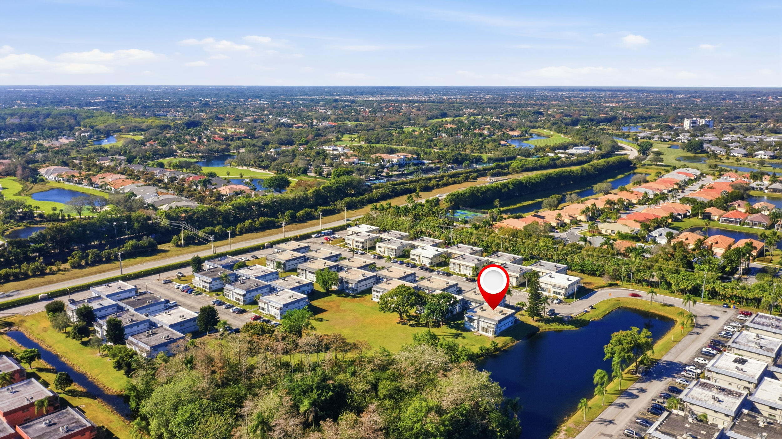 an aerial view of lake and residential houses with outdoor space