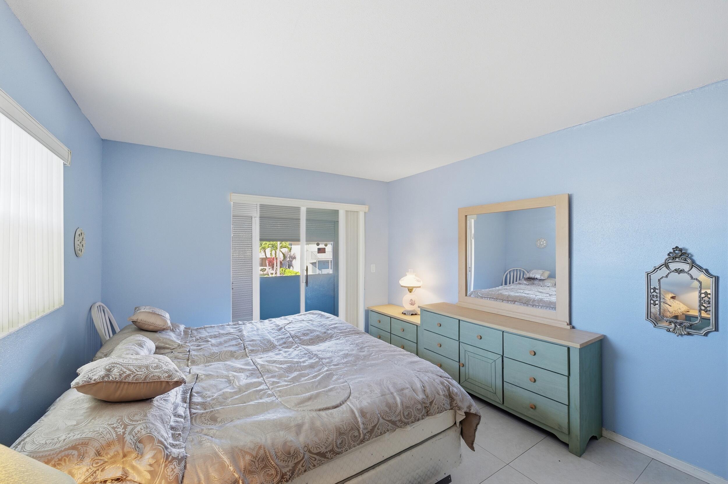 669 Saxony Place Delray Beach, FL 33446 - Photo 18 of 34 a bedroom with a bed and a dresser