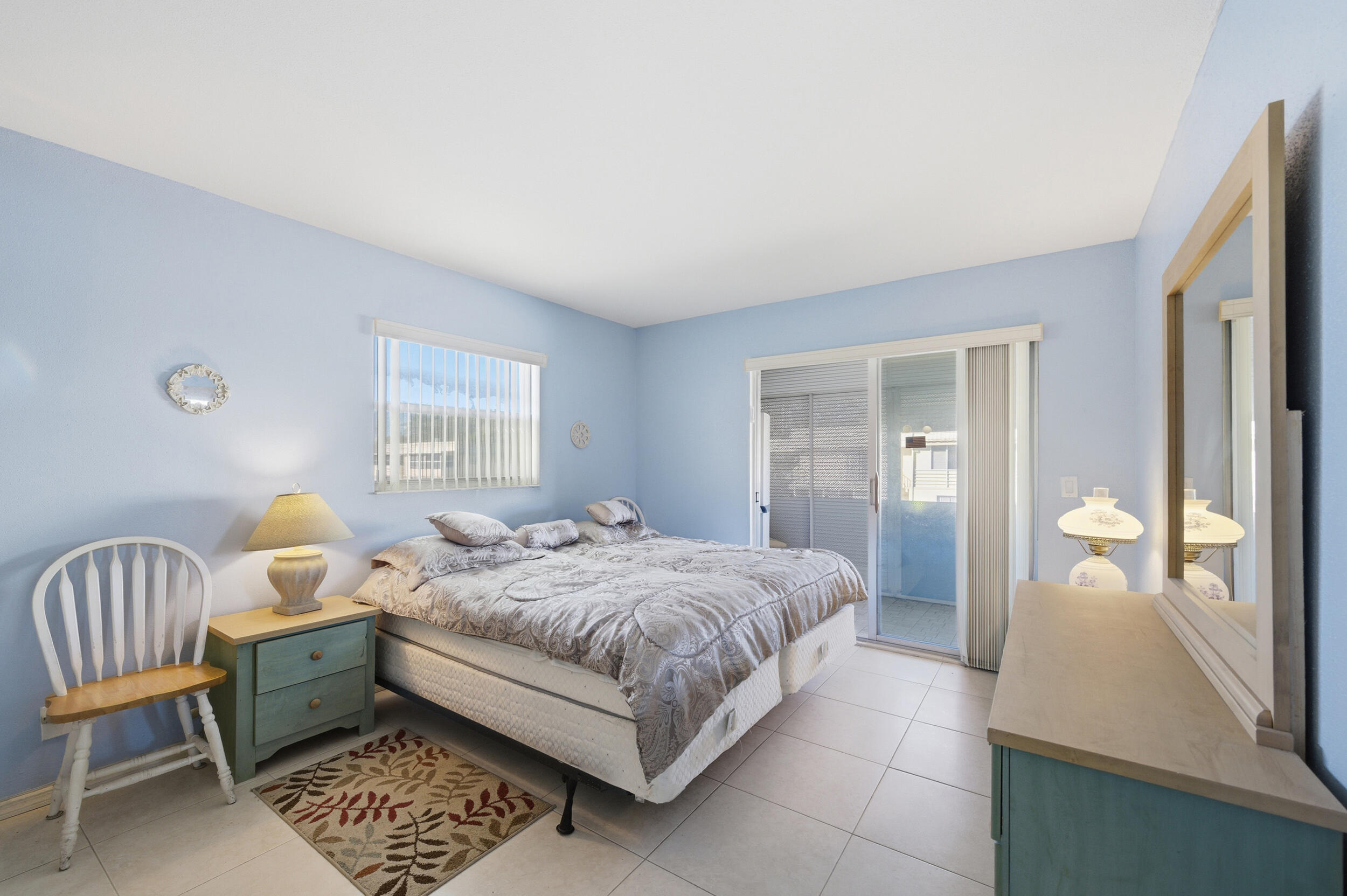 669 Saxony Place Delray Beach, FL 33446 - Photo 19 of 34 a bedroom with a bed and a dresser with mirror