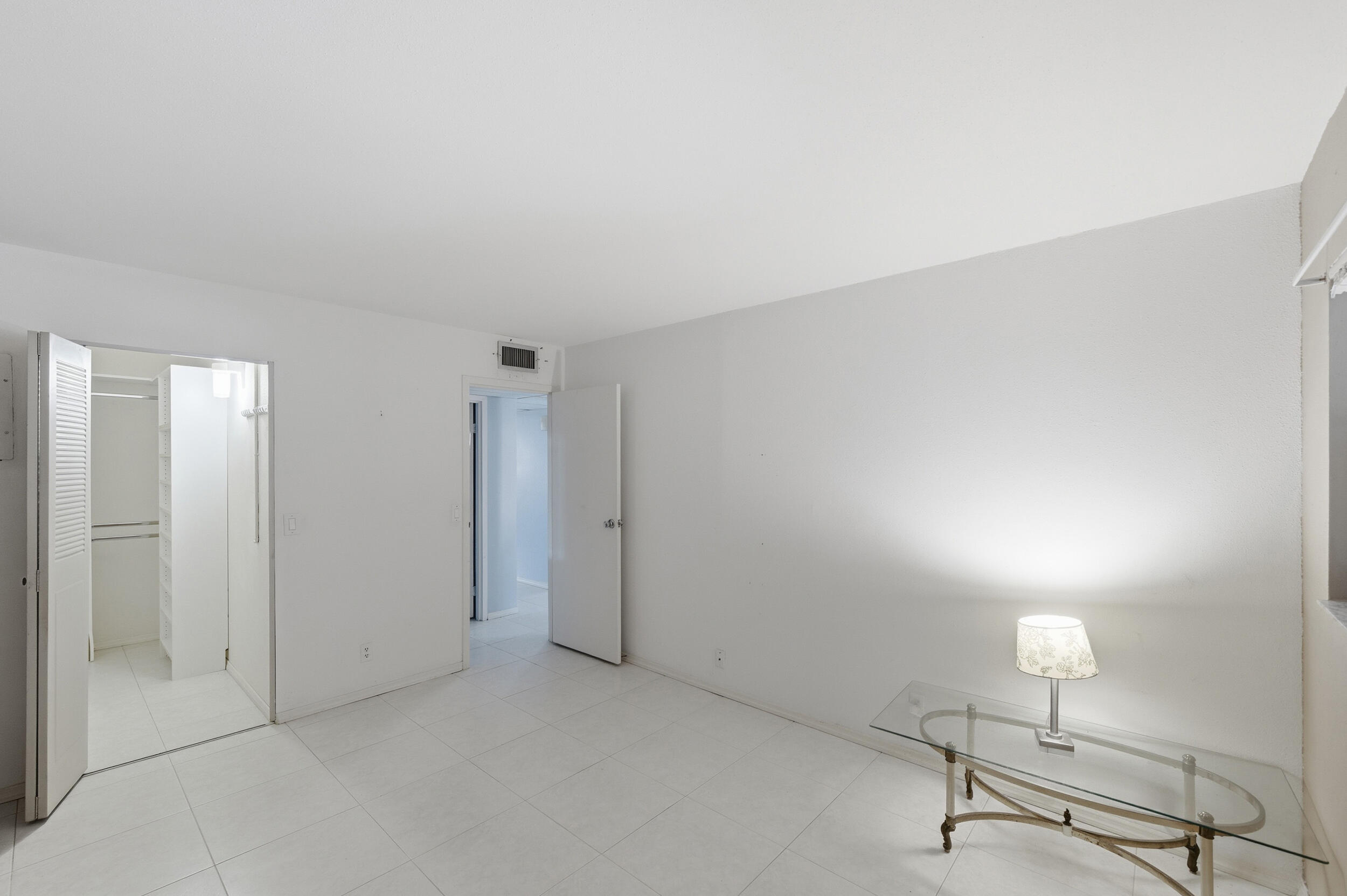 669 Saxony Place Delray Beach, FL 33446 - Photo 22 of 34 a view of a room with wooden floor and glass door