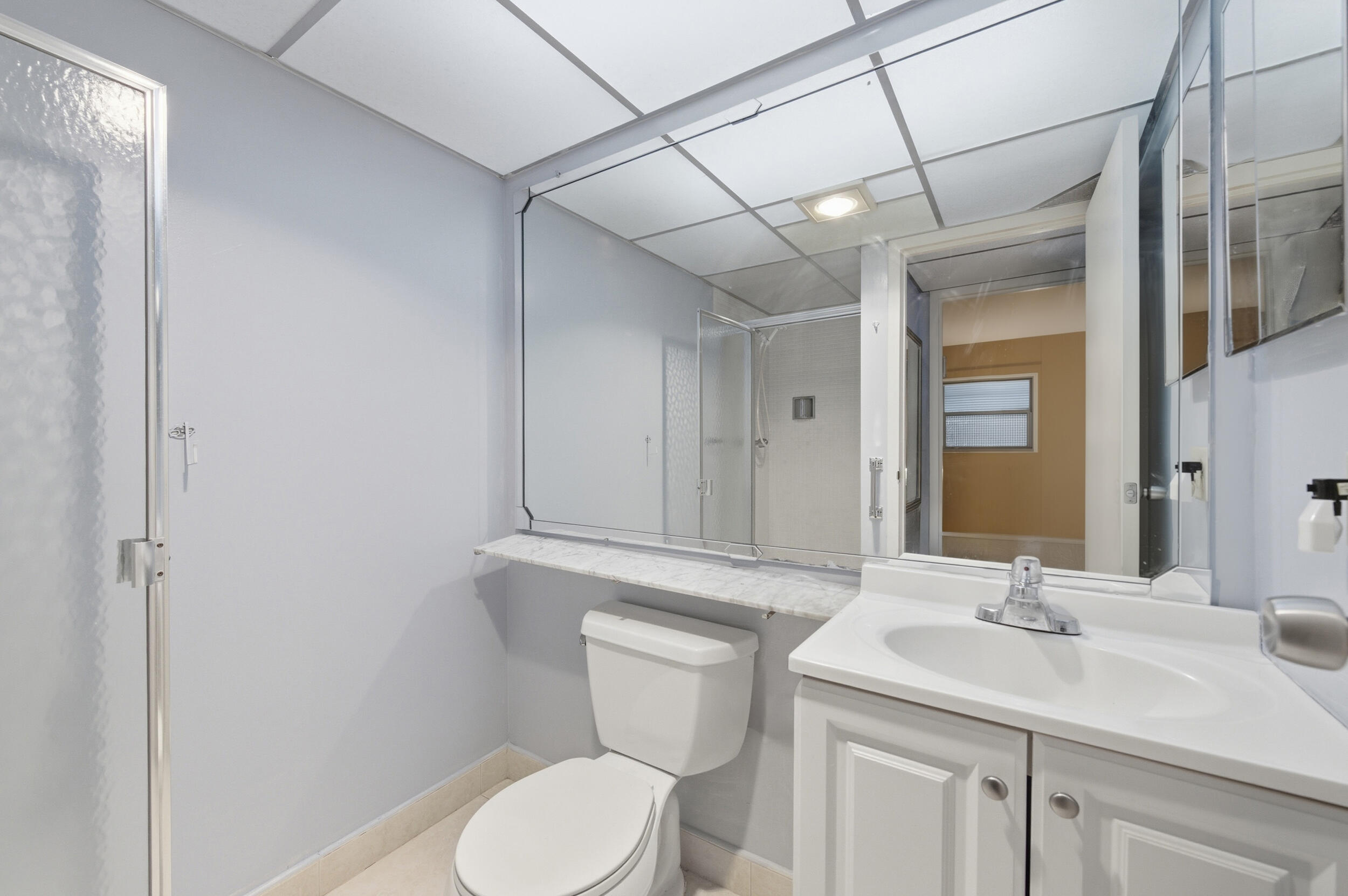 669 Saxony Place Delray Beach, FL 33446 - Photo 25 of 34 a bathroom with a toilet sink and mirror