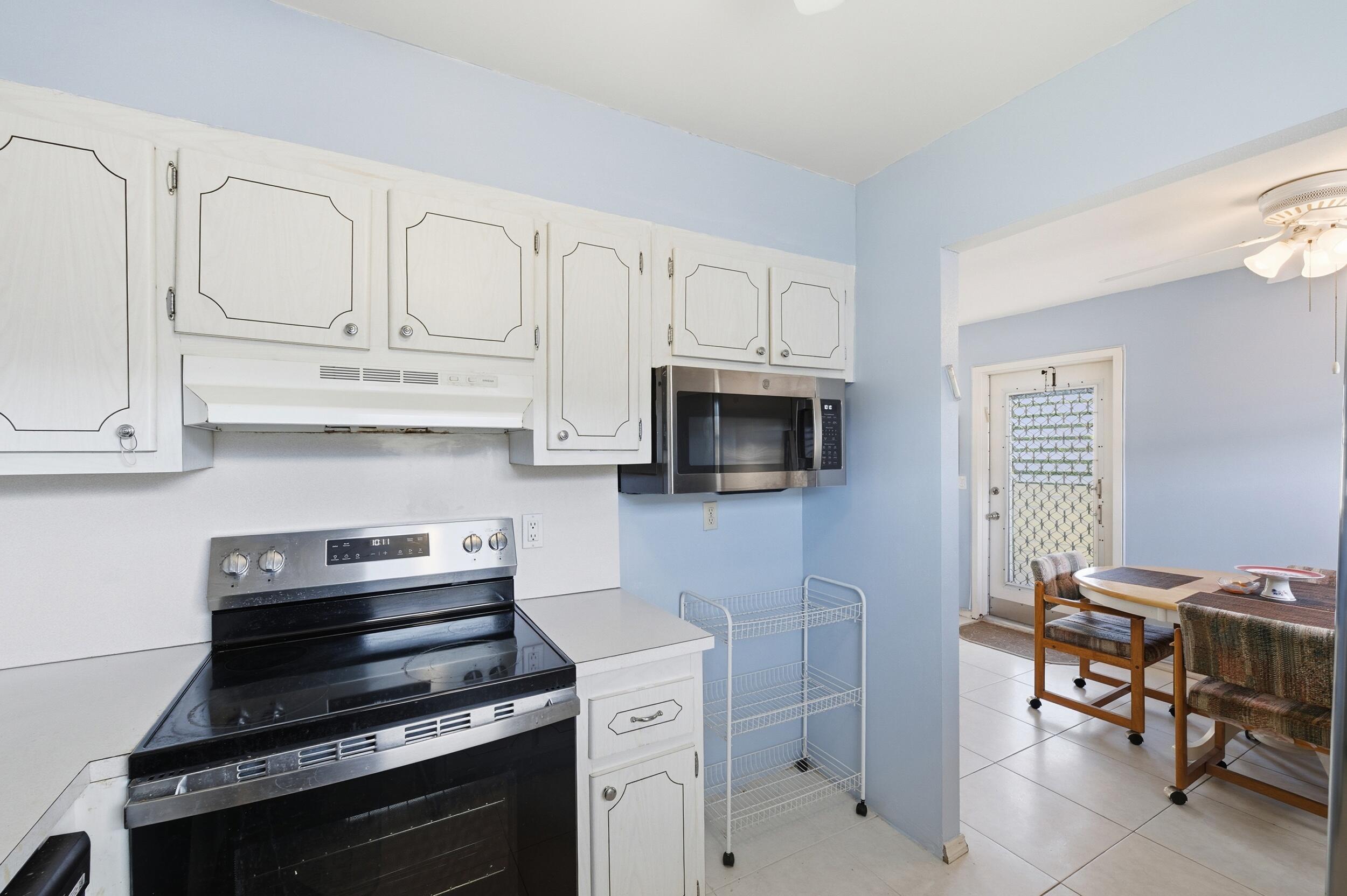 669 Saxony Place Delray Beach, FL 33446 - Photo 28 of 34 a kitchen with cabinets appliances and a counter space