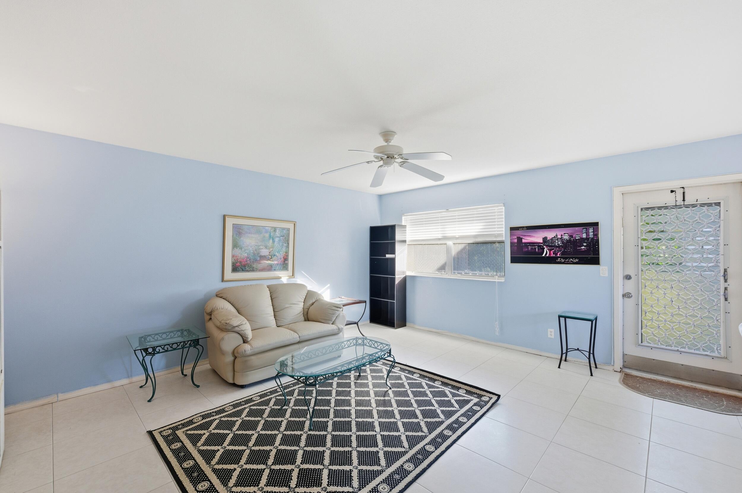 669 Saxony Place Delray Beach, FL 33446 - Photo 32 of 34 a living room with furniture and a rug