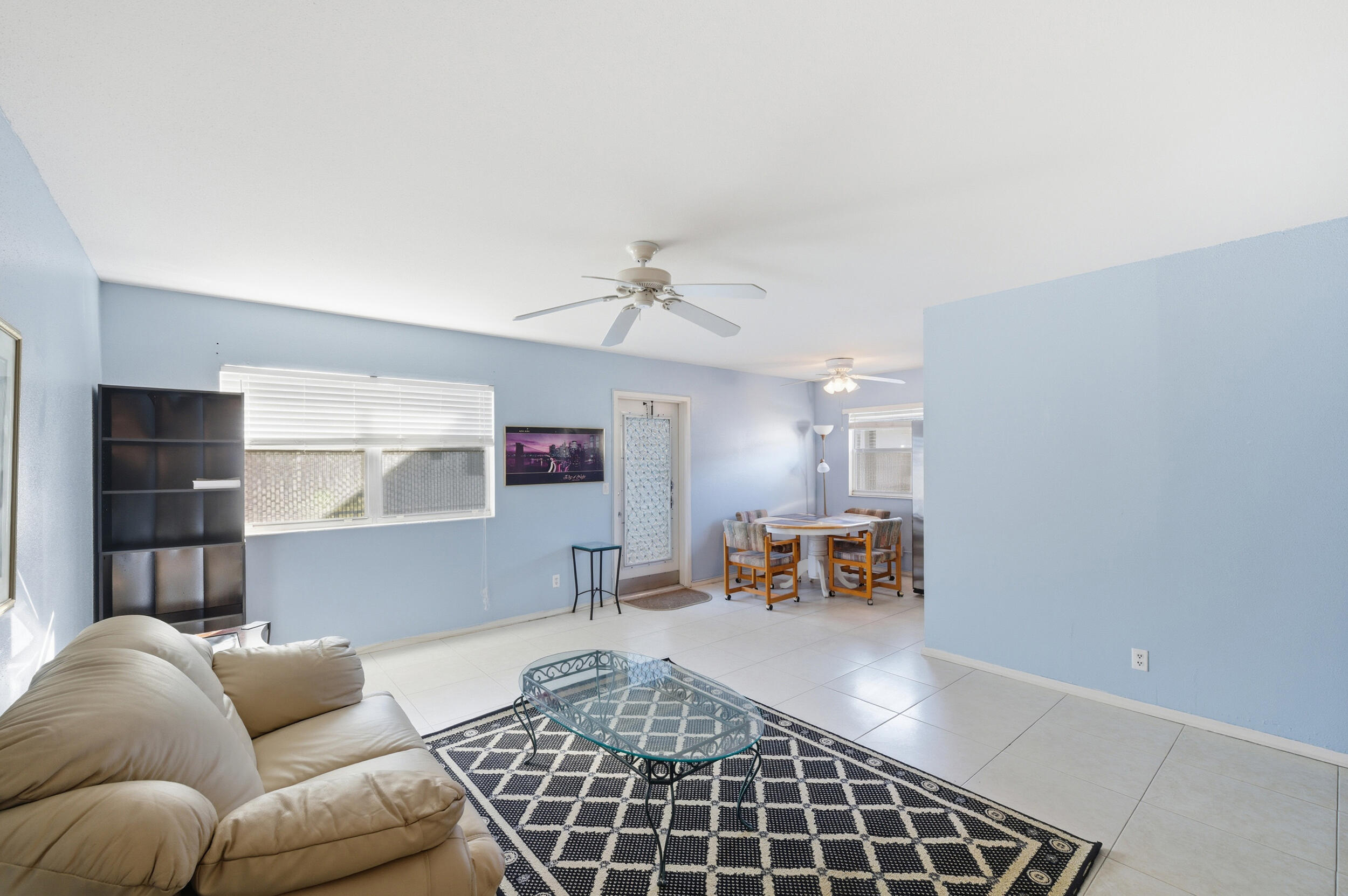 669 Saxony Place Delray Beach, FL 33446 - Photo 33 of 34 a living room with furniture and a chandelier