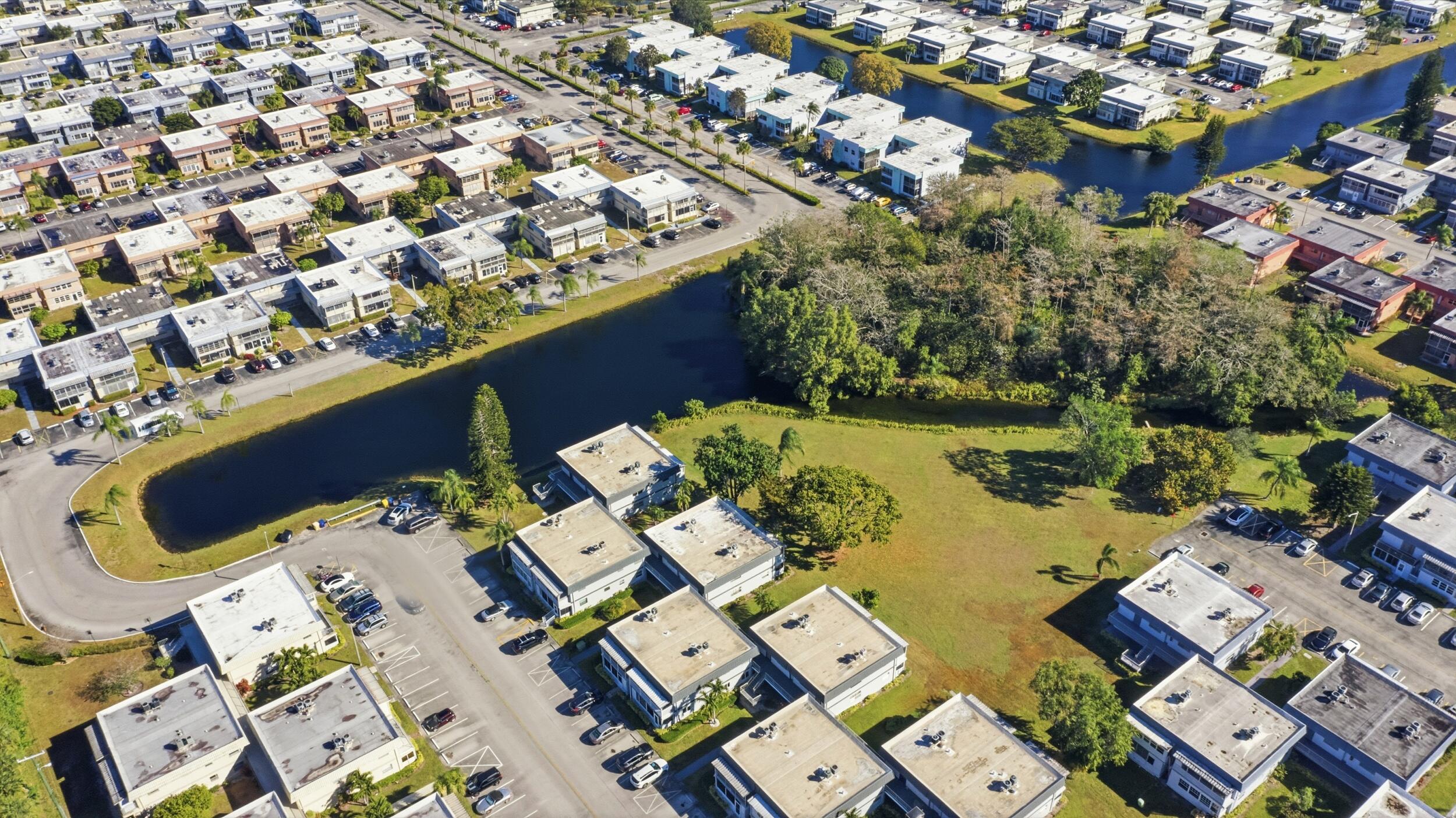 669 Saxony Place Delray Beach, FL 33446 - Photo 8 of 34 an aerial view of a house with a swimming pool and outdoor seating