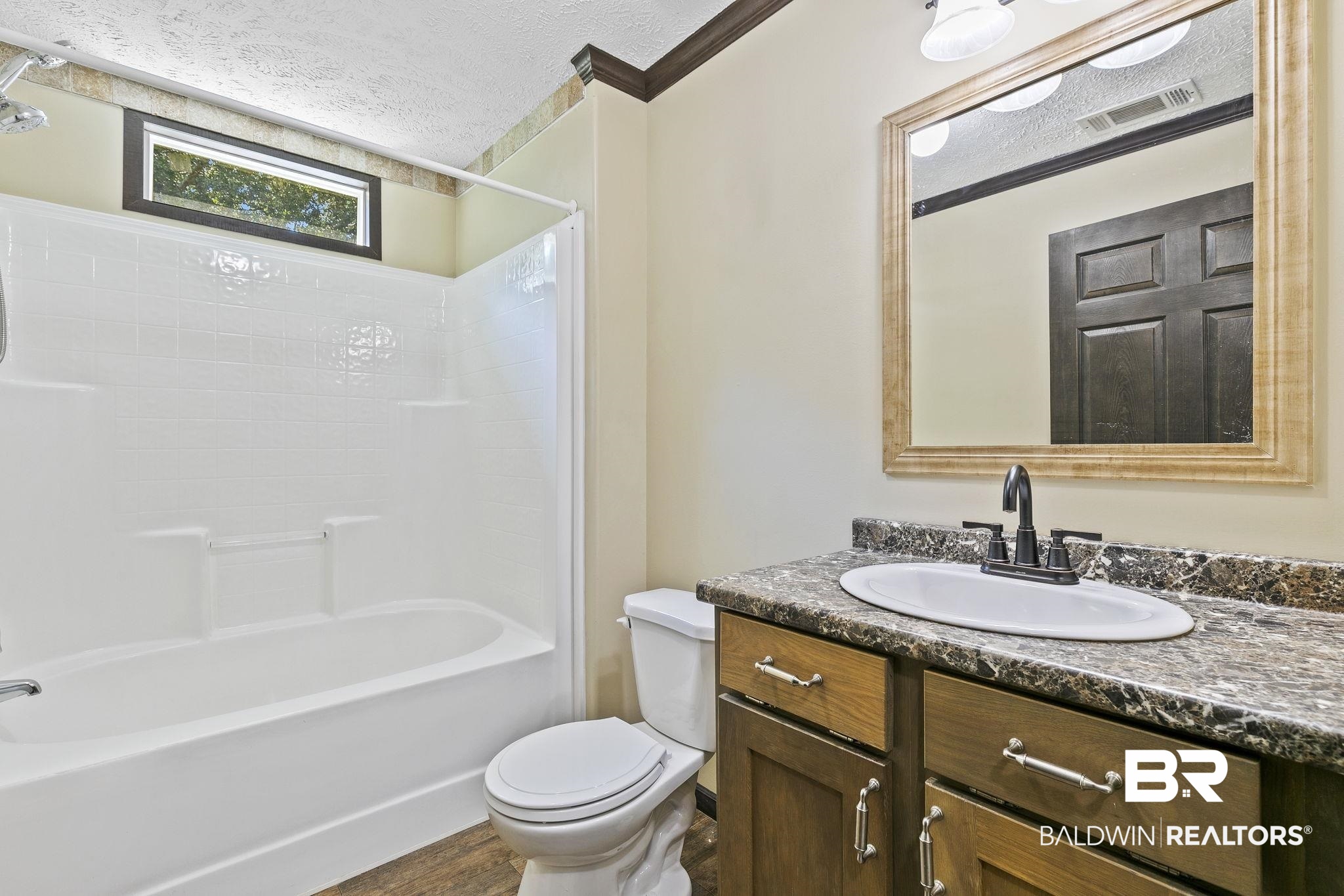 35641 County Road 39 Stapleton, AL 36578 - Photo 23 of 46 Full bathroom featuring vanity, ornamental molding, a textured ceiling, washtub / shower combination, and toilet