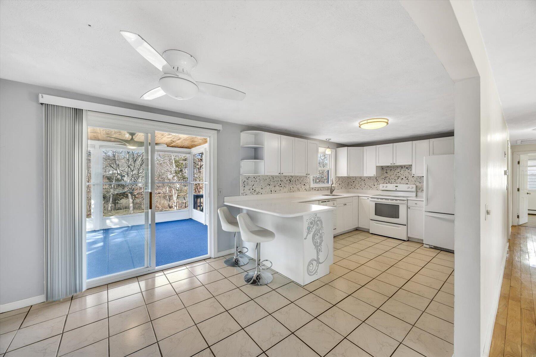 27 Madeline Road East Falmouth, MA 02536 - Photo 12 of 43 a kitchen with white cabinets and sink