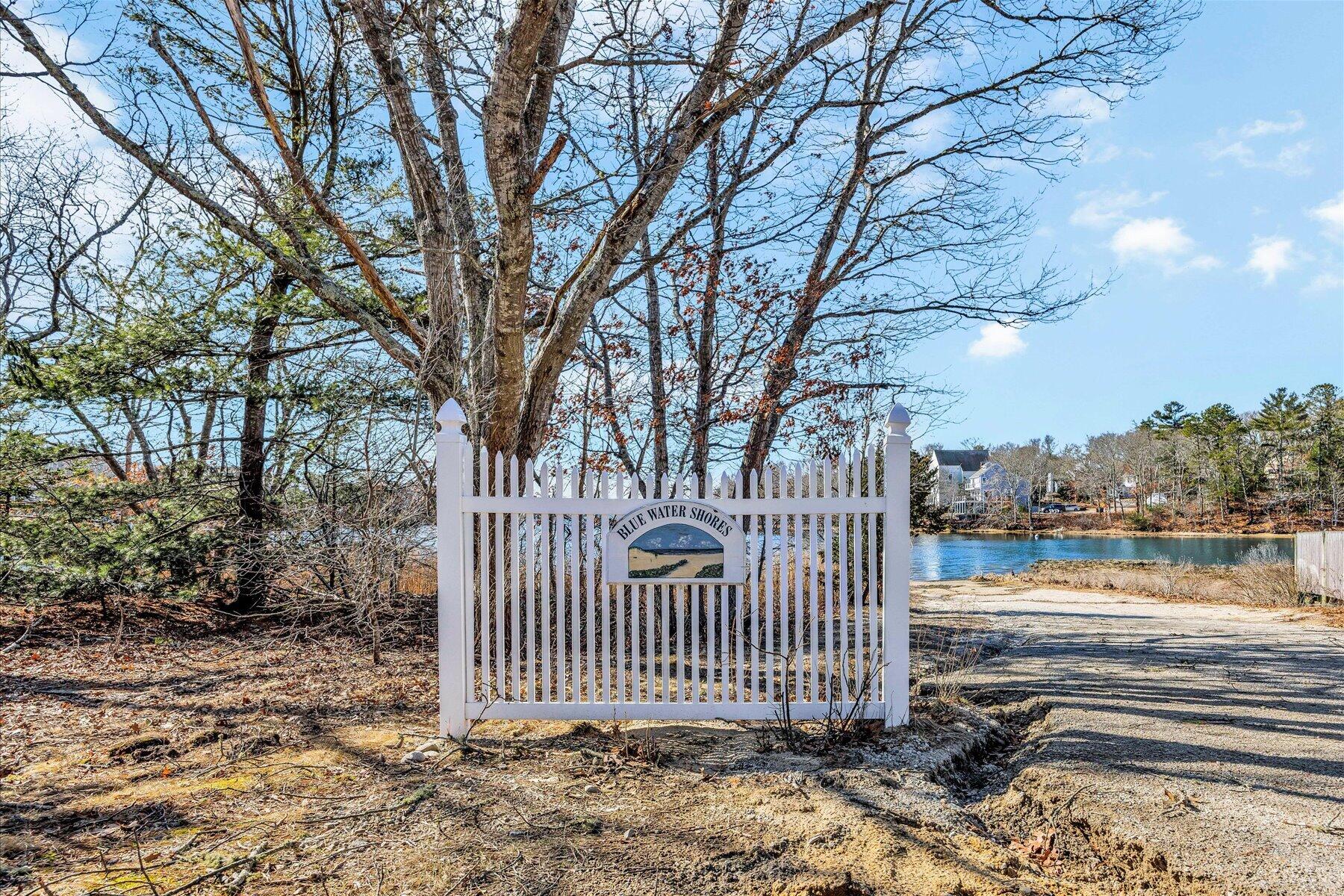 27 Madeline Road East Falmouth, MA 02536 - Photo 40 of 43 a view of a yard with large trees and wooden fence