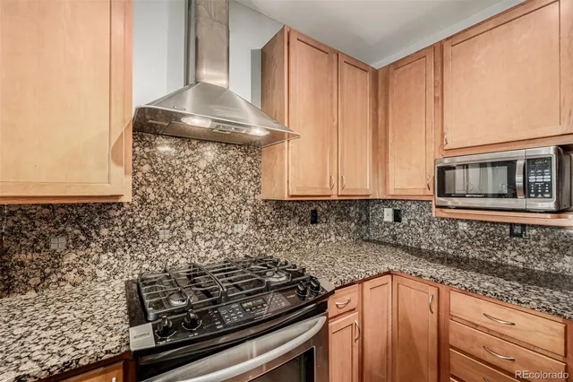 a kitchen with granite countertop a stove and a sink