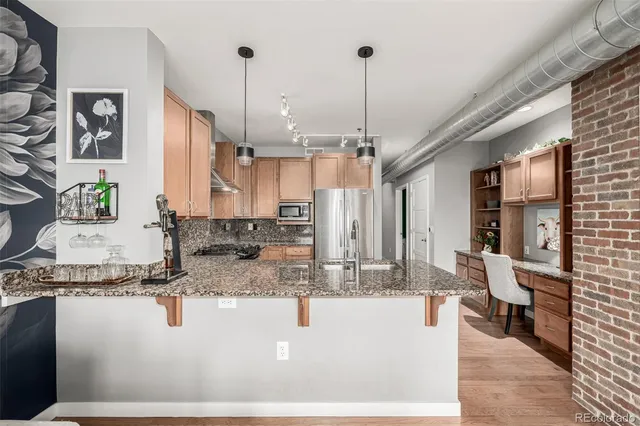 a kitchen with stainless steel appliances granite countertop a stove a sink and a granite counter tops