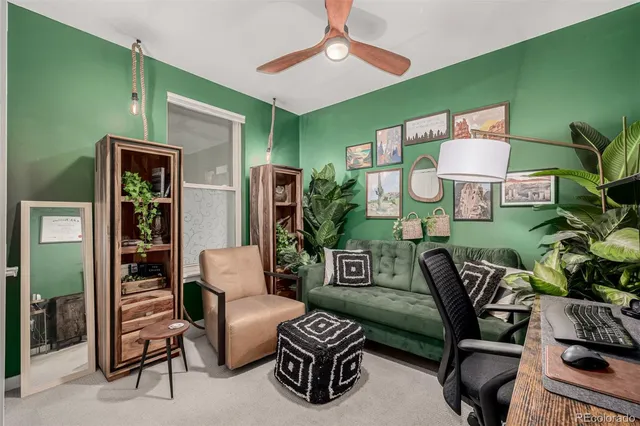 a living room with furniture a lamp and a window